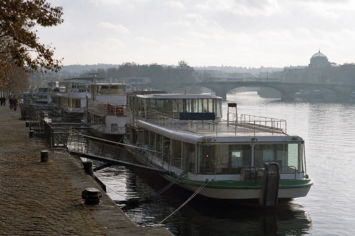 Cruise boats moored at the Dvořákovo nábřeží embankment pier in central Prague